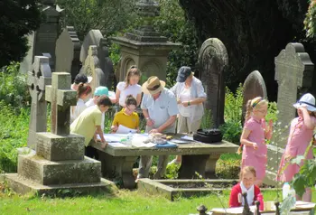 Workshop where children are doing rubbings on grave stones
