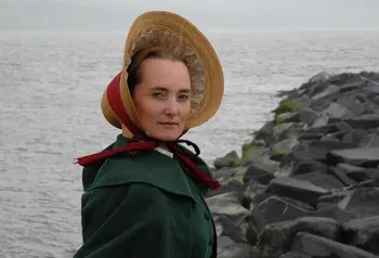 An actor in traditional dress standing on the Jurassic Coast