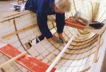 A volunteer working on boat restoration