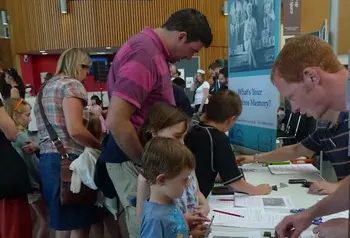 People visiting a Rowntree Society pop-up exhibition