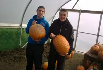 Young people showing off their food growing skills