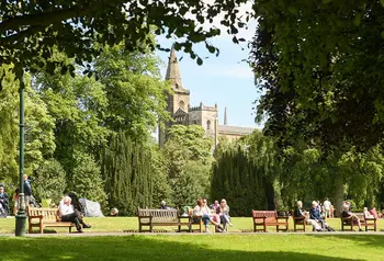 Visitors enjoying a picnic in a park in a city.