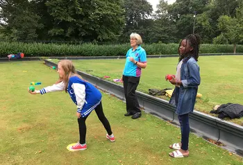 Children bowling outside