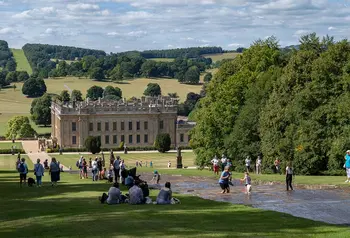 Visitors enjoy playing in the Chatsworth Cascade. Chatsworth House is in view in the distance.