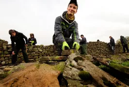 Man working on a dry stone wall in the North of England