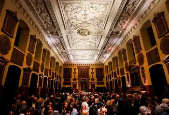 Visitors explore the recently transformed Great Hall. The decorated ceiling and donor boards are shown also.