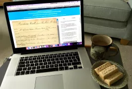 Computer, biscuits and hot drink