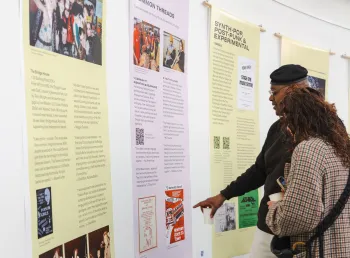 Two people looking at a display at the Sound Waves exhibition launch. 