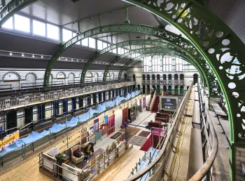 an empty historic swimming pool converted into an exhibition space