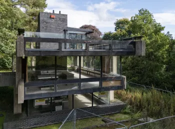 A view of the three levels of the Bernat Klein Studio, a brutalist concrete structure surrounded by woodland.