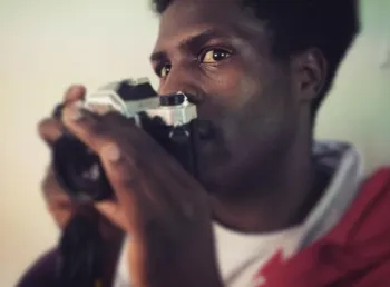 A young man with a camera