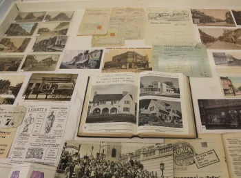 Heritage display for 'Woking's Story' exhibit, a collection of vintage postcards and books