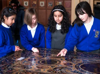 Children gathered around a table at a National Trust Property