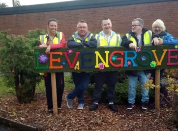 Group stand around park sign