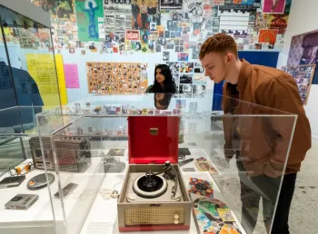 Museum of Youth image showing a person looking at a record player in a display