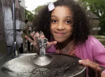 Girl using drinking fountain 