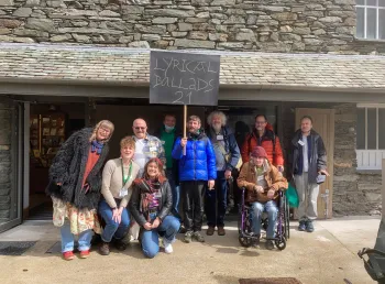A group of people standing in front of Wordsworth Museum. One of them is holding a sign that reads 'Lyrical Ballads 21' 