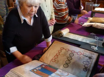 Visitors look at books and manuscripts in the collection