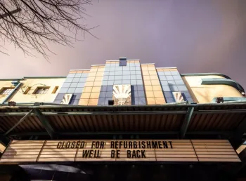 The art deco facade of the Strand Arts Centre with cinema lettering reading 'Closed for refurbishment. We'll be back"