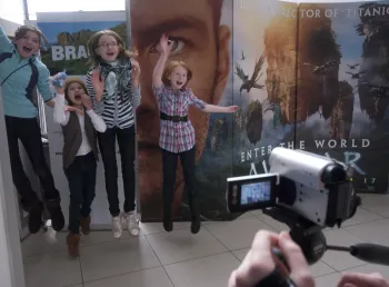 Children jump in front of a video camera
