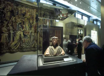 Man looks at statue in museum 