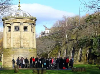 A group of people gathered in a graveyard