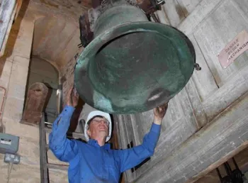 A volunteer restoring one of the bells at St Rumbald’s, Stoke Doyle 