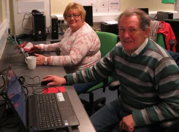 Man and a woman using computers