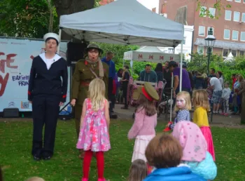 Two women dressed in male first world war uniform at family event