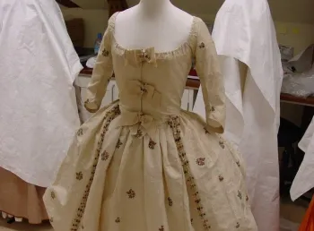 A crinoline-style skirt and matching bodice, in white cotton gauze with extensive beetle wing embroidery 