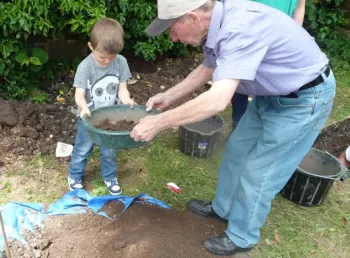 A child being shown the basics of archaeology