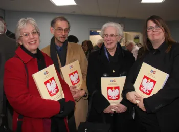 A group hold up books as part of the Poles in the Bristol Area project