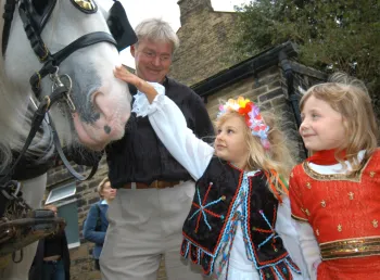 Children pet a horse at Bradford Industrial Museum