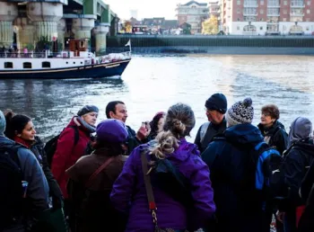 An expert explaining the historical significance of the docks, on site