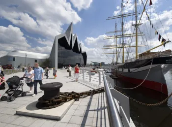 Visitors walk alongside Riverside Museum, Glasgow