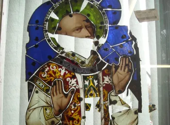 Broken pieces of stained glass window depicting St Ignatius Loyola 