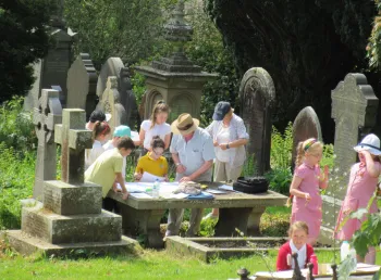 Workshop where children are doing rubbings on grave stones