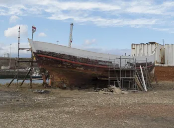 The hull of a boat being repainted