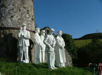 White statues of Victorian workers at the clay mine