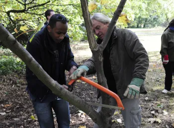 Trainer showing participant how to prune a tree