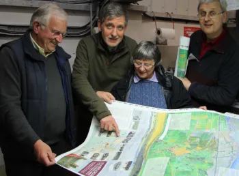 Volunteers from the Hadleigh and Thundersley Community Archive Group examine a walking map