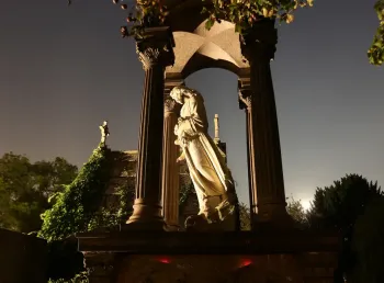 Statue at West Norwood Cemetery lit up at night