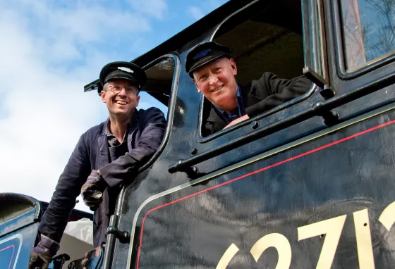 Two men in a steam train
