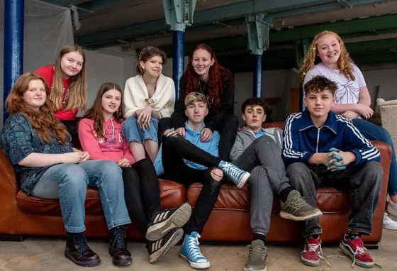 A revolution in industrial heritage Young people gathered around a red sofa