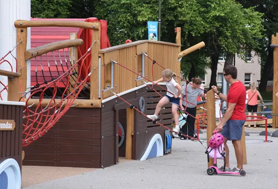 Zetland Park Family playing on playpark structures.