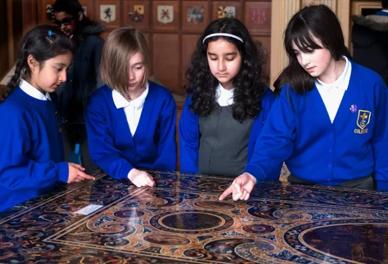 Children gathered around a table at a National Trust Property