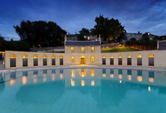 The restored Georgian lido Cleveland Pools in Bath lit up at night