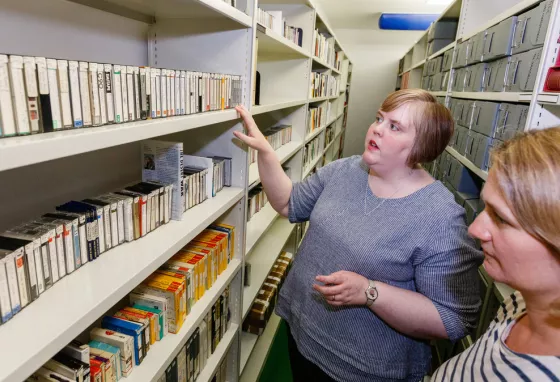 Digitising the legacy of disability champion Leonard Cheshire Two people looking at tapes on shelves