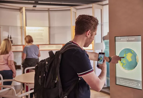 Man taking a picture of himself using a touchscreen at an interactive exhibition