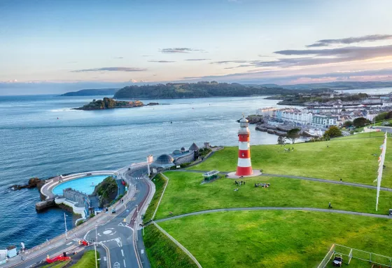 Aerial view of Plymouth's coast, with the lighthouse and lido in view